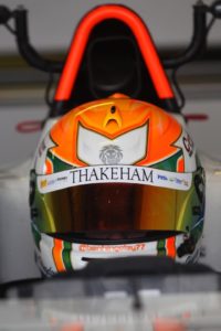 ben in his cockpit, his helmet shows off his sponsor thakeham